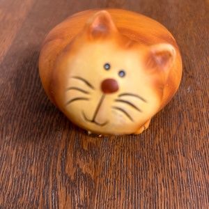 Clay cat with a gold bell collar.